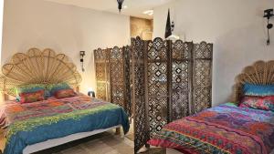 a bedroom with two beds and a large gate at Loft entre vignes et truffes - Gite en Provence Vaucluse in Valréas +41 photos