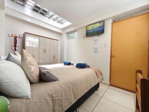 a bedroom with a large bed with a skylight at Killitas home&apart in Cusco