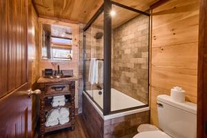 a bathroom with a tub and a toilet and a sink at The Derby Inn in Hot Springs +25 photos