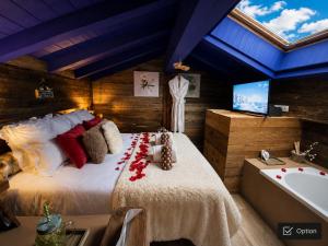 a bedroom with a large bed and a bath tub at Micro-lodge, Le Petit Nid d'Amour in Montriond