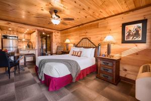 a bedroom with a bed in a wooden room at The Derby Inn in Hot Springs
