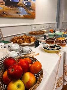 a buffet with apples and other foods on a table at Hotel Luina in Stresa +31 photos