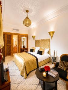 a hotel room with a bed and a table at Riad Zamzam & Spa in Marrakesh
