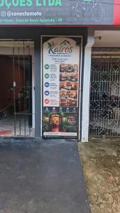 a store with a sign on the front of a building at Kairos Pousada e Hostel in Cabo de Santo Agostinho