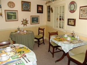 a dining room with two tables and chairs at Hazels Roost in Bainbridge
