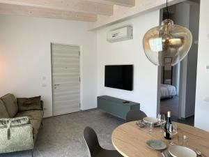 a living room with a table and a couch at Oliveto Apartments in Riva del Garda
