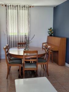 a dining room with a table and chairs and a piano at La Petite Pierre d'Octave Nr 1 in Saint Laurent Nouan