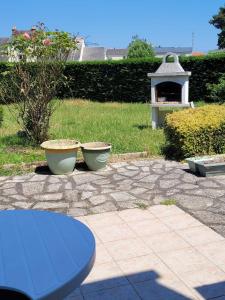 a patio with a table and a pizza oven at La Petite Pierre d'Octave Nr 1 in Saint Laurent Nouan