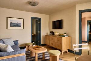 a living room with a couch and a table at Hotel Corduroy in Montauk