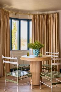 a dining room with a table and two chairs at Hotel Corduroy in Montauk