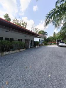 a parking lot in front of a building at ทุ่งจับช้างโฮมสเตย์ in Pumriang