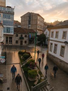 a group of people walking down a street at Pensión 813 in Palas de Rei +21 photos