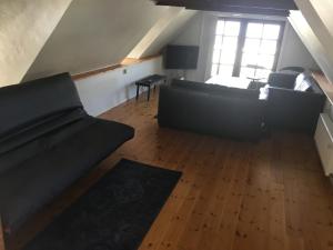 a living room with two couches and a table at Det Bette Hus in Fladbjerg