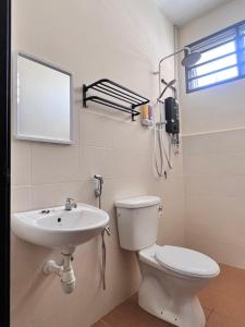 a bathroom with a toilet and a sink at MiD Guest House in Gambang +11 photos