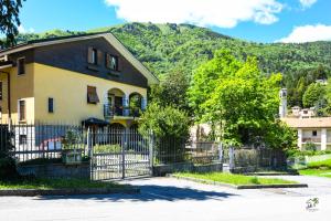 a house with a fence in front of a mountain at Appartamenti La Menaresta quiet & relax near Bellagio in Magreglio +120 photos