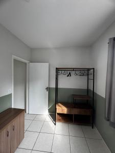 a room with a room with a shelf and a door at Aconchegante Apartamento in Lavras +6 photos