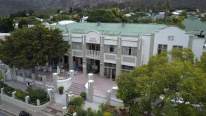 a large white building with a green roof at Montagu Country Hotel in Montagu