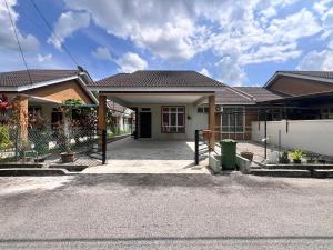 a house with a driveway in front of it at MiD Guest House in Gambang