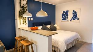 a bedroom with a bed and a table with chairs at Luxury Coastal Escape Coral Point Sibaya Pool & WiFi in Durban