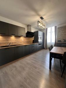 a kitchen with a table and a dining room at Tain centre -T3- wine themed apartment in Tain-lʼHermitage