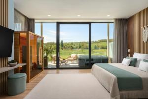 a bedroom with a bed and a view of a golf course at Evergreen Health Longevity Residence in Kehidakustány +49 photos