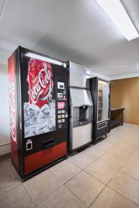 a cocacola machine and a refrigerator in a room at The Derby Inn in Hot Springs