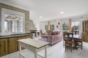 a kitchen and living room with a couch and a table at Casa de Piedra in El Cañal