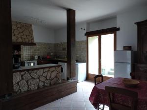 a kitchen with a table and a kitchen with a window at Grès Vaillant in Saint-Polycarpe