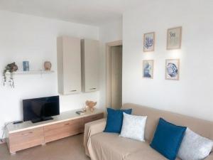 a living room with a couch and a flat screen tv at Casa Angela in Olbia