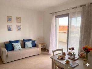 a living room with a couch and a table at Casa Angela in Olbia +17 photos