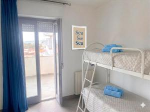 a room with two bunk beds and a sliding glass door at Casa Angela in Olbia
