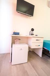 a desk with a sink and a tv on a wall at Prestige House 7 in Scalea +15 photos