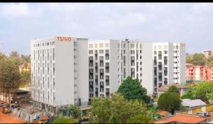 a tall white building with a tmo sign on it at Royalty homes in Kiambu