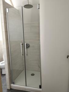 a shower with a glass door in a bathroom at Gîte la Bourgeoise in Bléré
