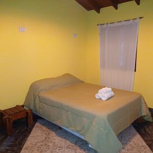 a bedroom with a bed with a towel on it at Génesis in Merlo