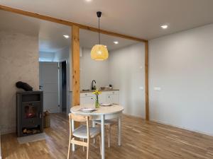 a kitchen with a table and chairs and a stove at Türi Cozy Apartment in Türi +2 photos