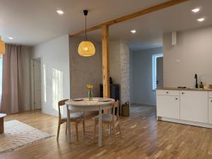 a kitchen and dining room with a table and chairs at Türi Cozy Apartment in Türi