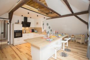 a kitchen with a large island in a room at Denkmal Haus Hugo in Medebach