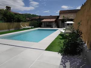 a swimming pool in the backyard of a house at La Corte di Marga Ginetta 2 - Prosecco Hills Holidays in Miane