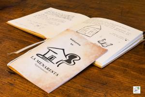 two notebooks sitting on a table with handwriting on them at Appartamenti La Menaresta quiet & relax near Bellagio in Magreglio