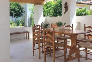 a wooden dining room table and chairs on a porch at La Corte di Marga Ginetta 2 - Prosecco Hills Holidays in Miane