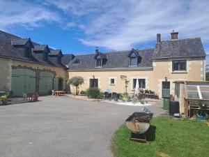 a large house with a driveway in front of it at Studio 80m2 a la ferme tout confort in Courdemanche