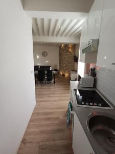 a kitchen with a sink and a stove top oven at Au Thiernois in Thiers