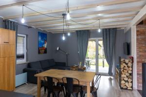 a living room with a table and a couch at Leśna Przystań in Sasino