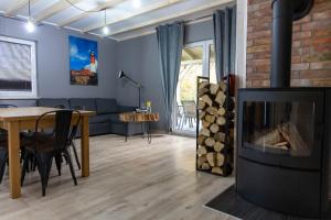 a living room with a couch and a fireplace at Leśna Przystań in Sasino