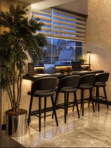 a dining room with a table and chairs with laptops on it at Laodikya Hotel in Denizli +19 photos