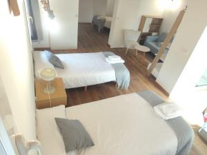 a small room with two beds and a living room at Casa Toronzue in Frajén