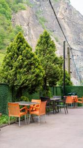 a group of tables and chairs with trees in the background at 53 BRN hotel in Ardeşen