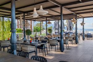a restaurant with tables and chairs on a patio at Corendon Hydros Club Kemer - Ultra All Inclusive in Kemer