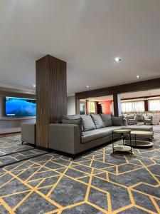 a living room with a couch and a table at Peko's Multiparque Hotel in Villa Santa Cruz del Lago